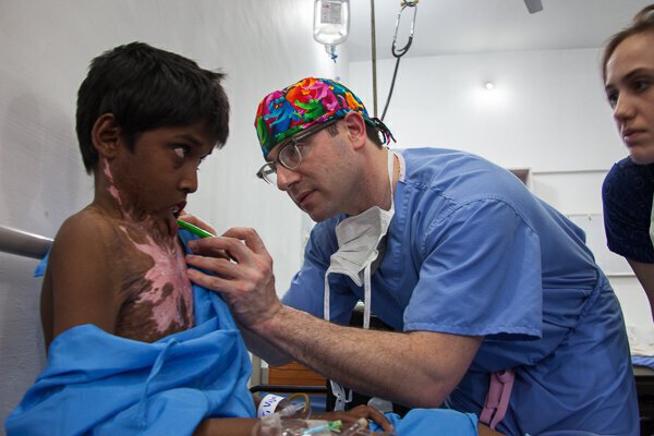 Dr. Trovato is examining the patient before the surgery.